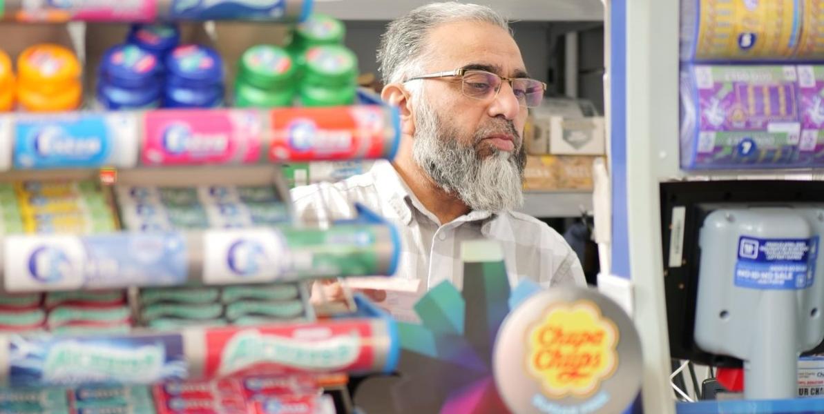 Close up of newsagent trader behind counter at Restvale Close up of newsagent trader behind counter at Restvale