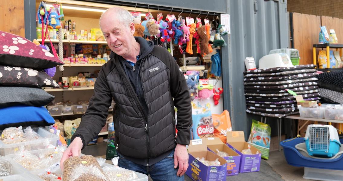 Pet Stop Pet Supplies trader sorting pet food