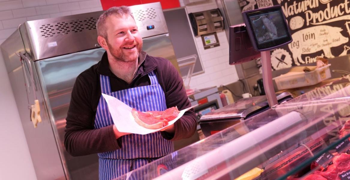 Livesey's trader holding meat