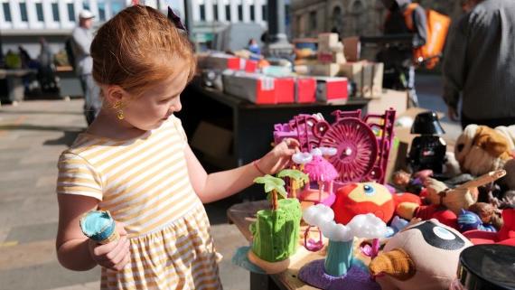 Girl browsing the toy stall