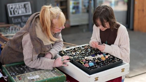Karen's Collectables trader looking through items 