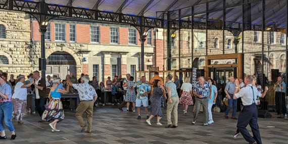 People dancing under the Victorian canopy