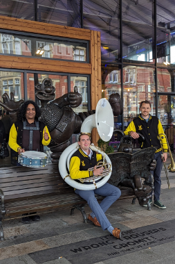 Little Brass band sat on Wallace and Gromit bench