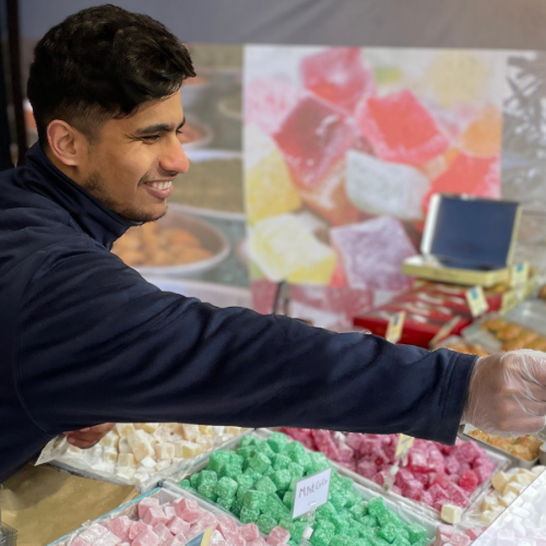 International Market trader serving customer