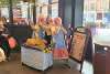Dinner lady performers joking around with customers inside Preston Market Hall