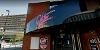 Entrance to Blitz music venue in Preston, with retro pink neon sign above door.